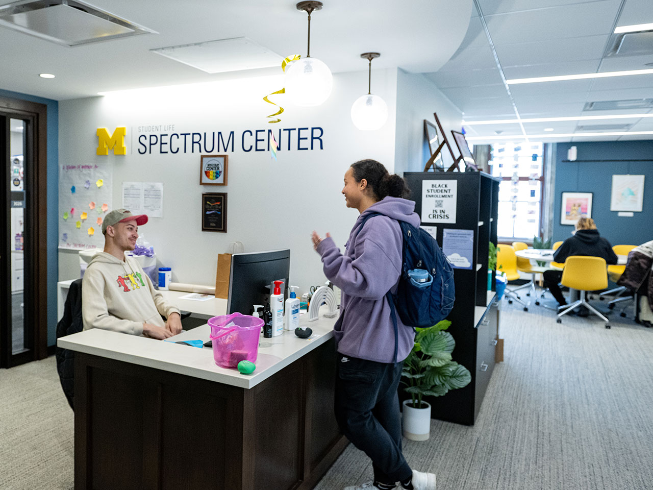 Photo of the front desk at Spectrum, with a student speaking to a front desk student assistant