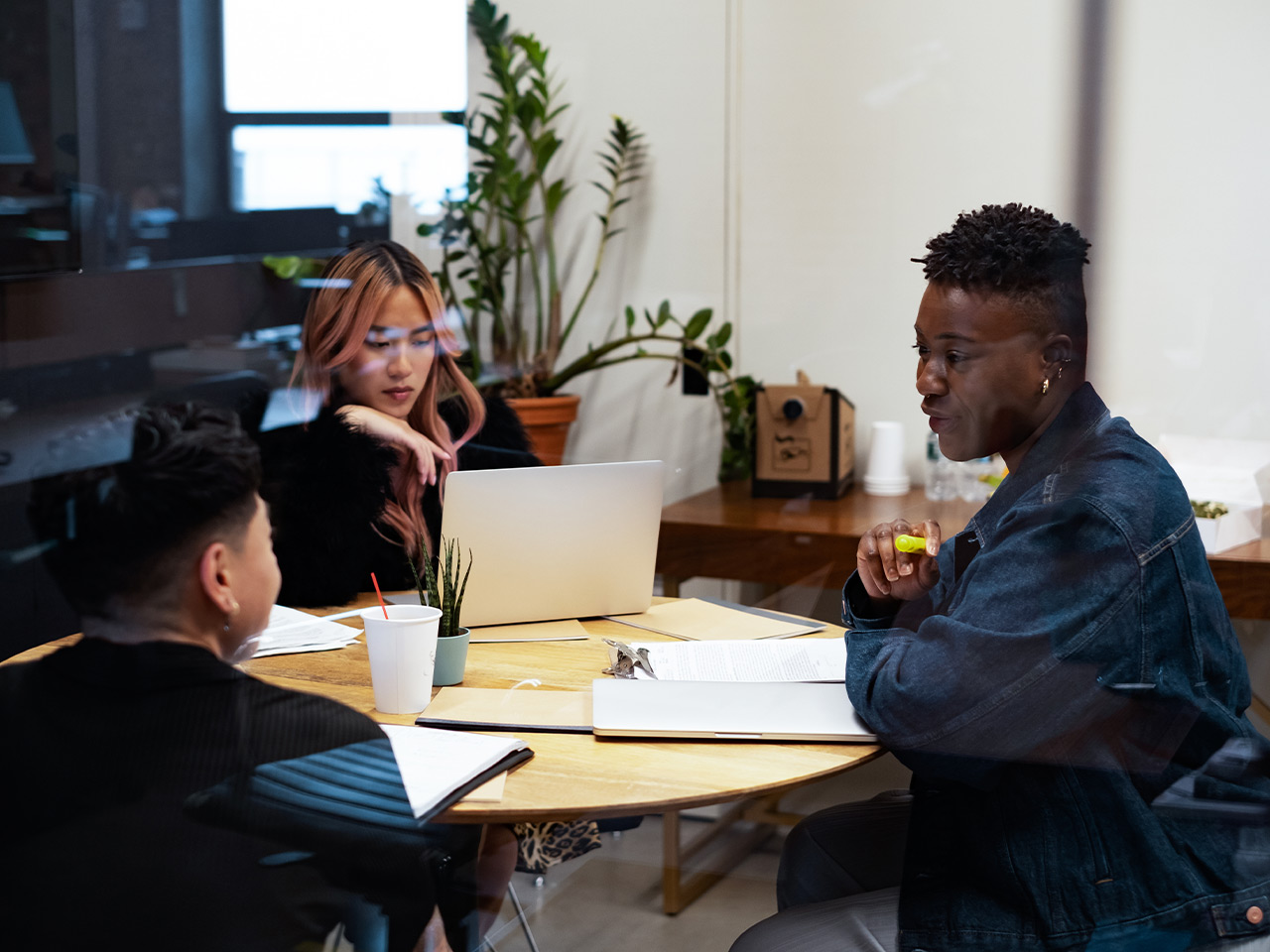 A group of co-workers of varying genders having a meeting