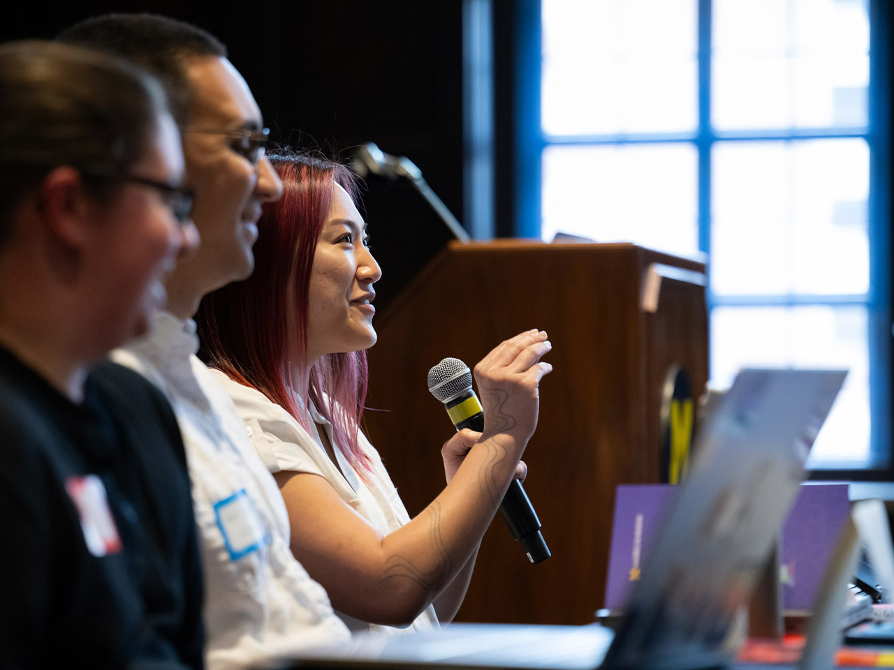 A panelist speaks to attendees not appearing in the photo