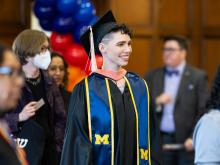A Lavender Graduate walks into the ballroom