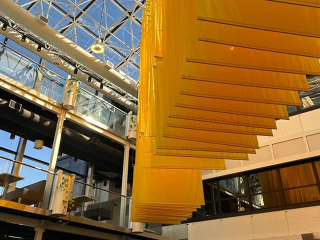 Photo of SAB from inside looking up at maize banners and glass features
