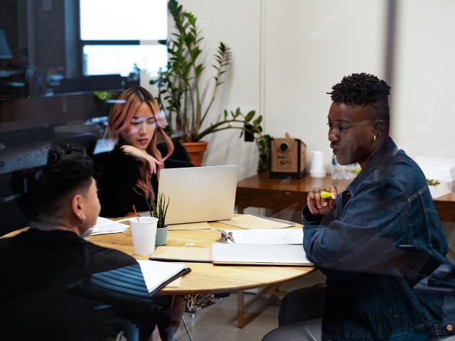 Photo of a group of people meeting around a table