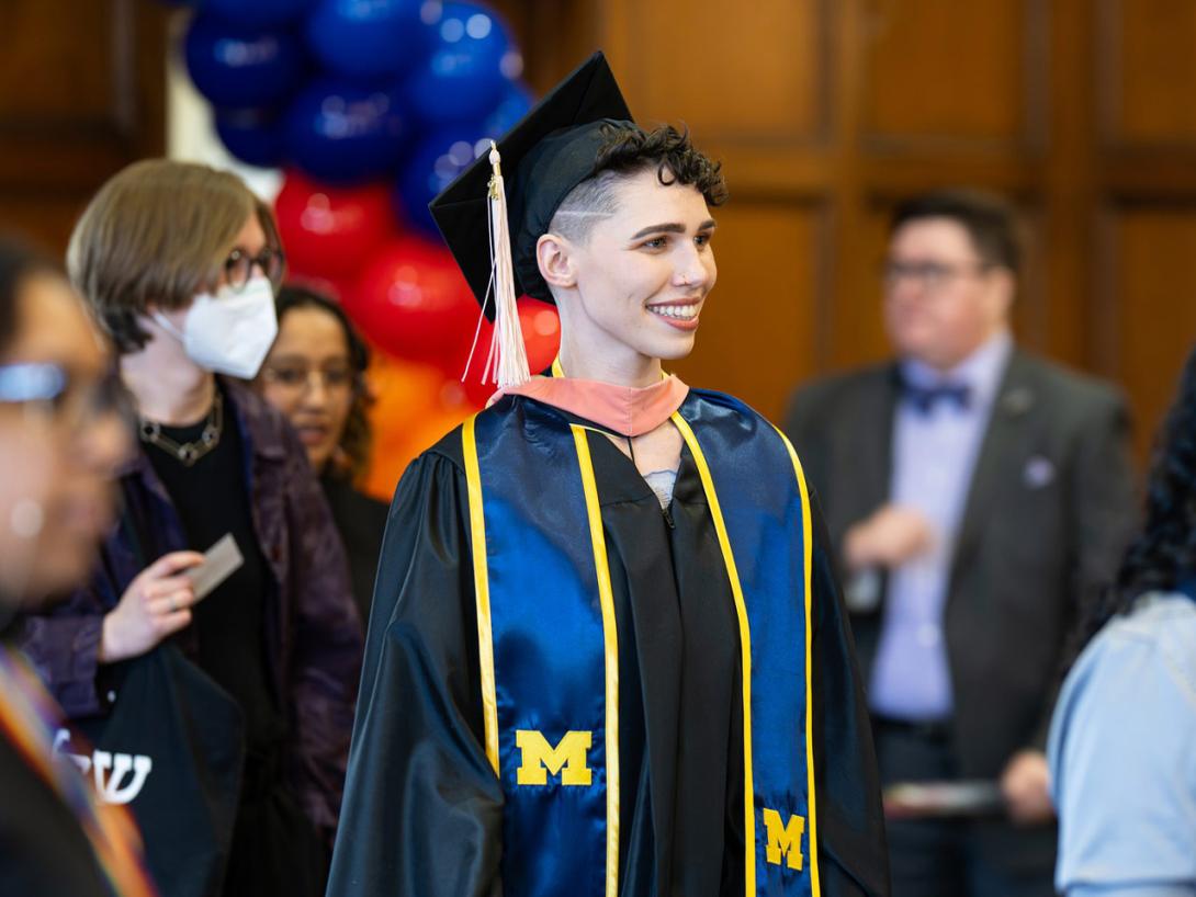 A Lavender Graduate walks into the ballroom