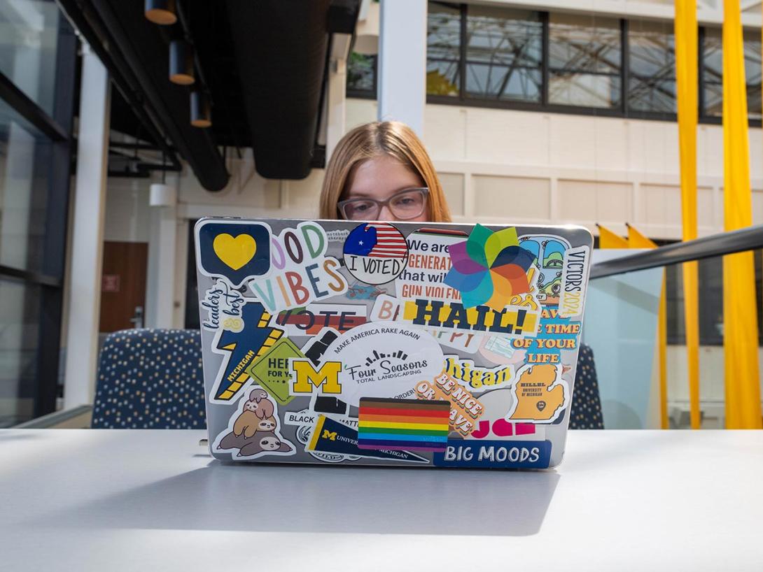 A student works at their computer on campus